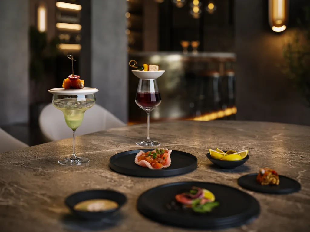 Villeroy & Boch: ZOA Studio close-up rendering of stemware and a cocktail glass on a stone bar top in a dark restaurant